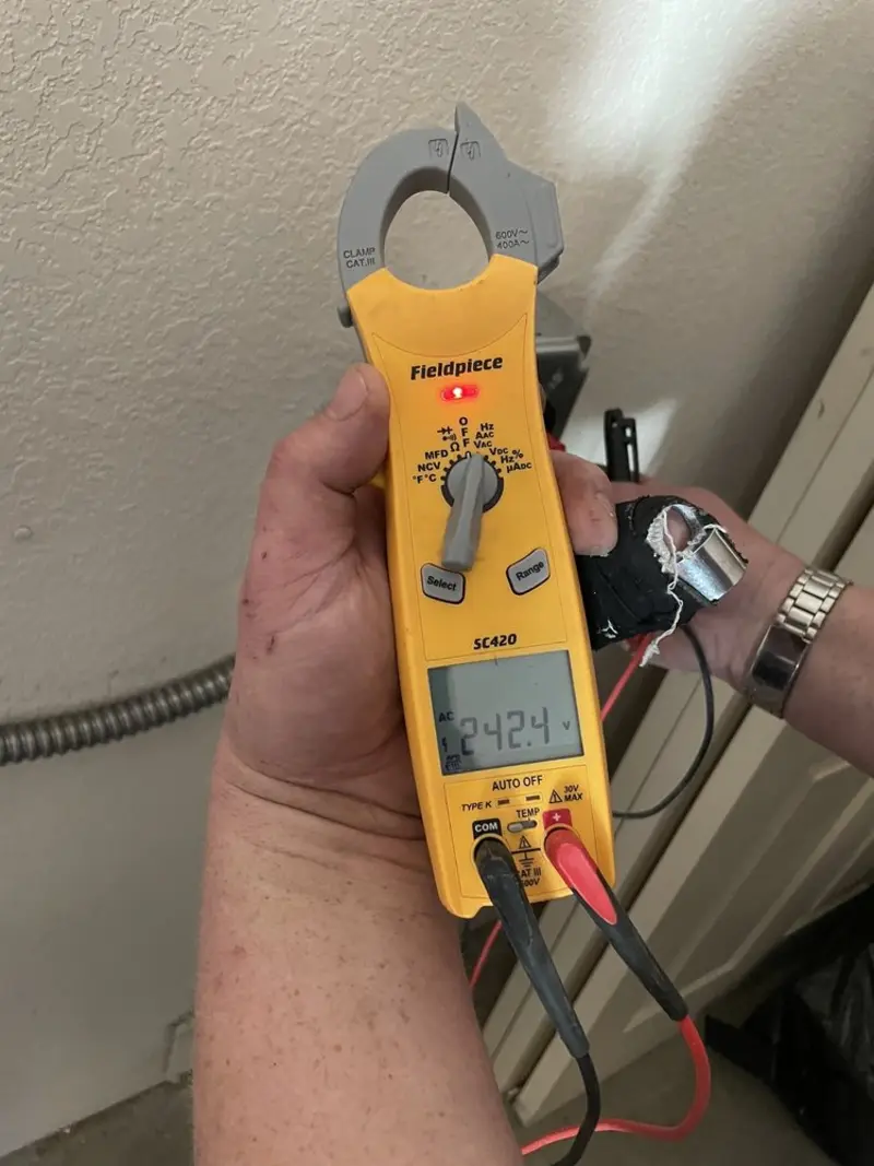 Voltage testing with clamp meter during Outlet Installation in Selma